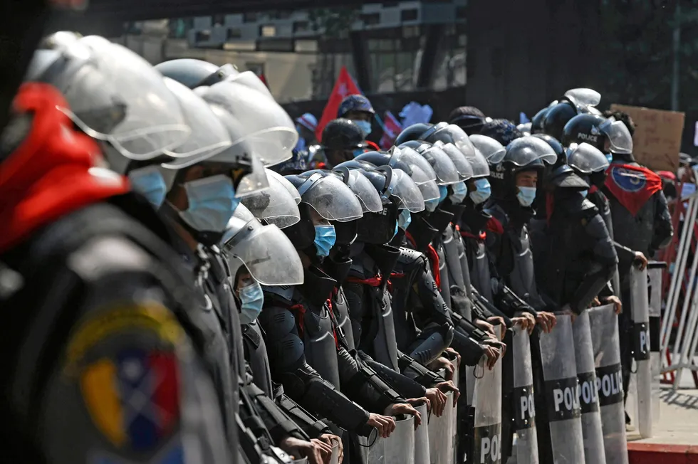 On guard: riot police stand ready as protesters take part in a demonstration against the military coup in Yangon this week