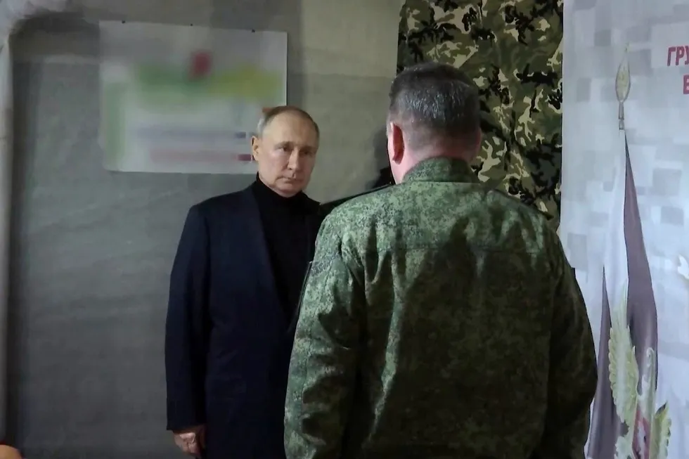 Under suspicion: Vladimir Putin visiting Russian national guard headquarters in the Lugansk region in the east of Ukraine.