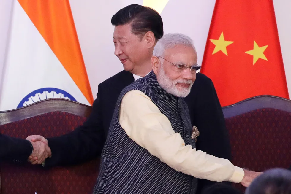 Crude buyers: Indian Prime Minister Narendra Modi (front) and Chinese President Xi Jinping shake hands with leaders at a 2016 BRICS summit in Goa, India.