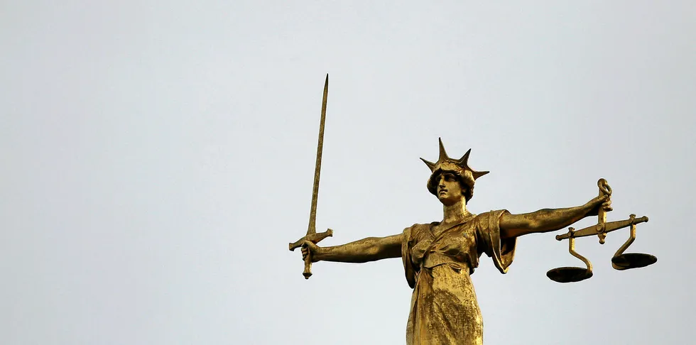 A statue of the scales of justice stands above the Old Bailey on February 16, 2015 in London, England.