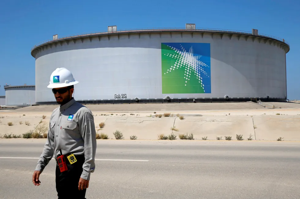 Software deal: An Aramco employee walks near an oil tank at Saudi Aramco's Ras Tanura oil refinery and oil terminal in Saudi Arabia