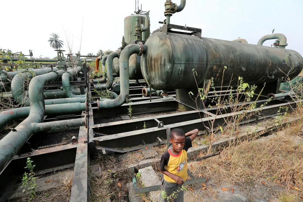 Kids play on broken pipework at an abandoned oil flow station operated by Royal Dutch Shell Plc in K-Dare, Nigeria, on Wednesday, Jan. 13, 2016. Twenty years after the oil-pollution crisis in the Niger delta shot to world attention when the then military government hanged the author and environmentalist, Ken Saro-Wiwa, residents in the region are seething with anger again that the problem hasn’t been fixed. Photographer: George Osodi/Bloomberg ---