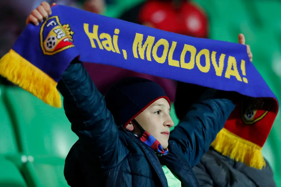 Tough game: a Moldova fan cheers on his team during the FIFA World Cup Qatar 2022 qualification football match between Moldova and Denmark at Chisinau's Zimbru Stadium in October