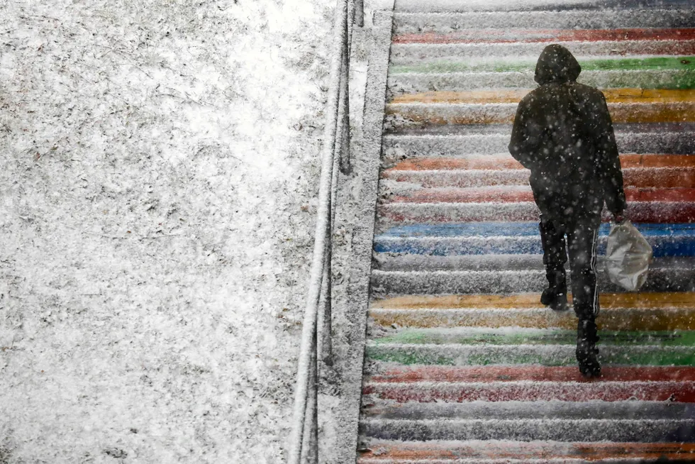 Deep freeze: a man walks on the stairs during snowfall in the city of Krakow, Poland