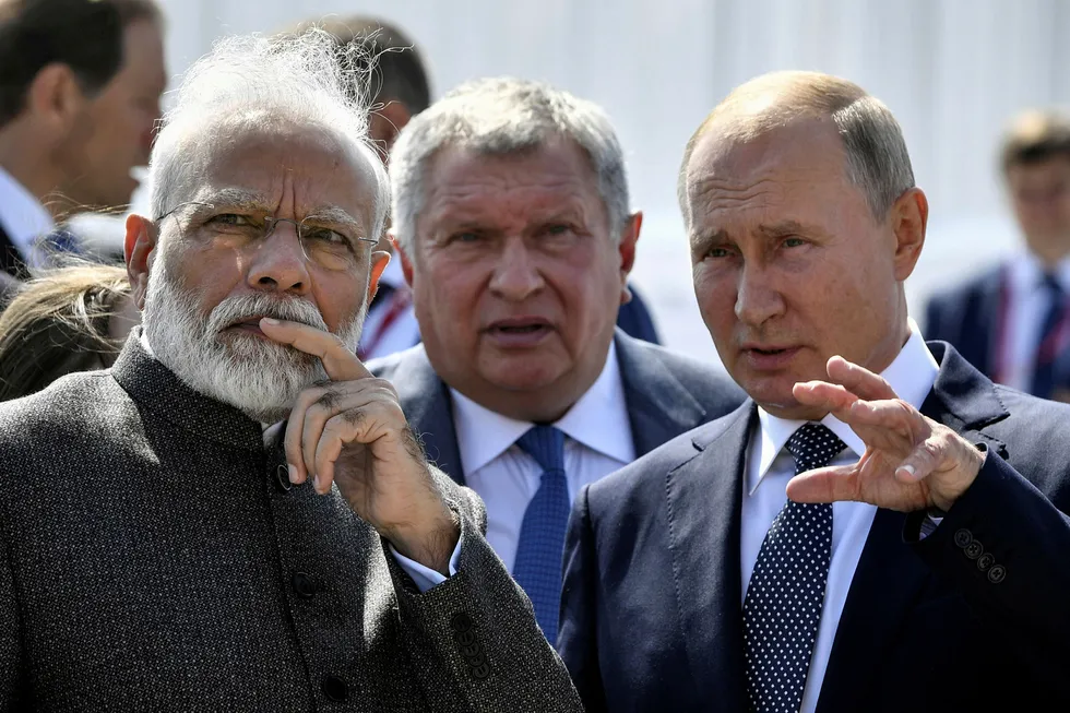 Proposals: Russian President Vladimir Putin and Rosneft executive chairman Igor Sechin whisper to Indian Prime Minister Narendra Modi during his visit the Zvezda shipyard in the Far East of Russia last September