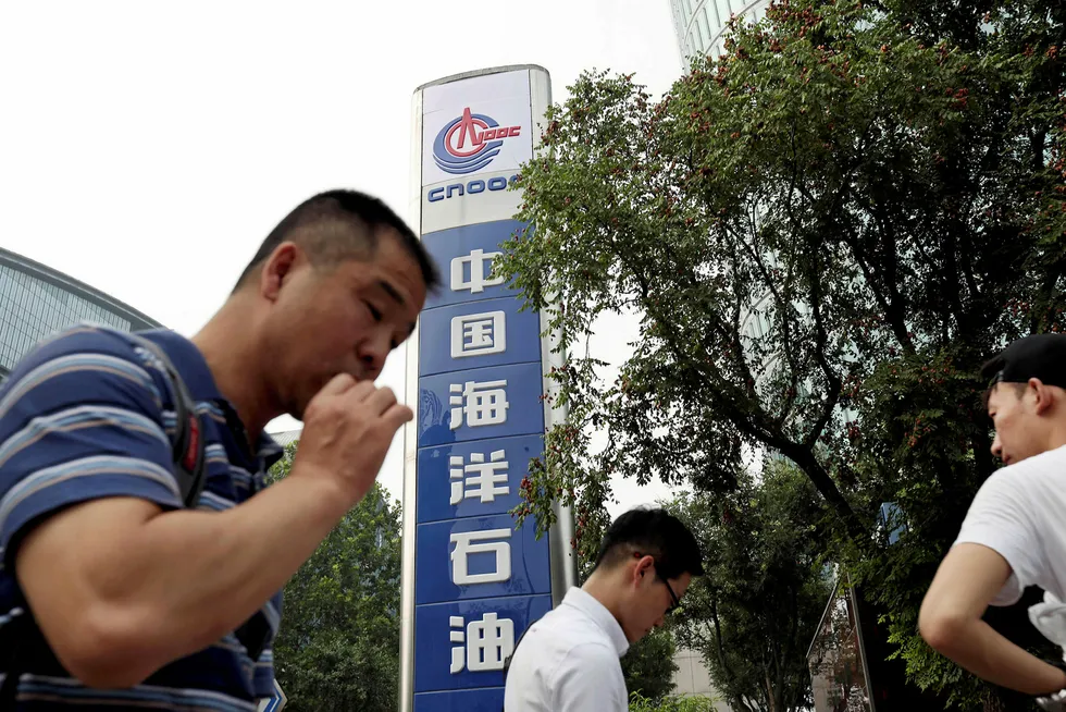 Centre point: people walk past CNOOC's headquarters in Beijing