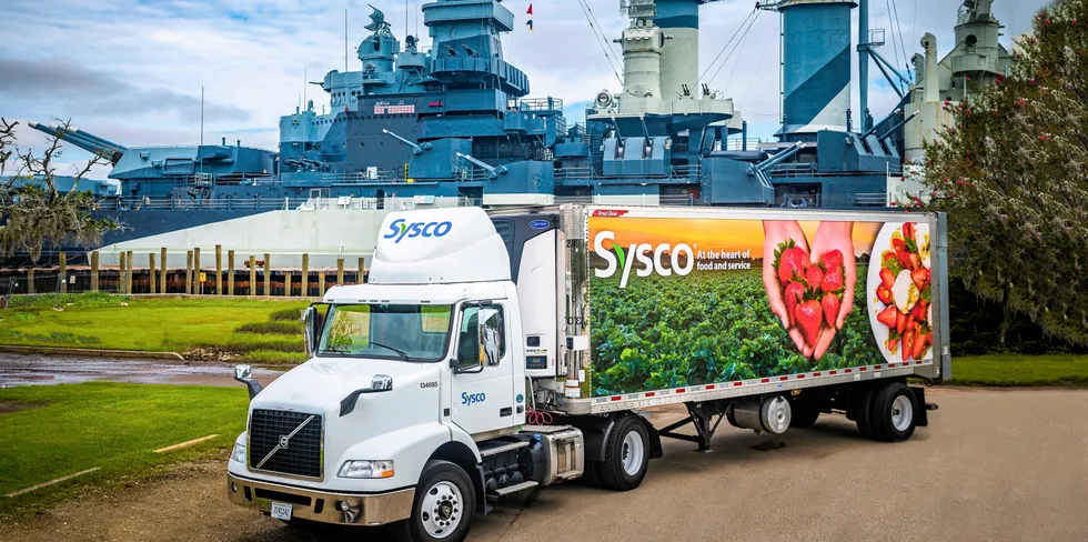 A Sysco truck waiting to offload cargo onto a US naval vessel.