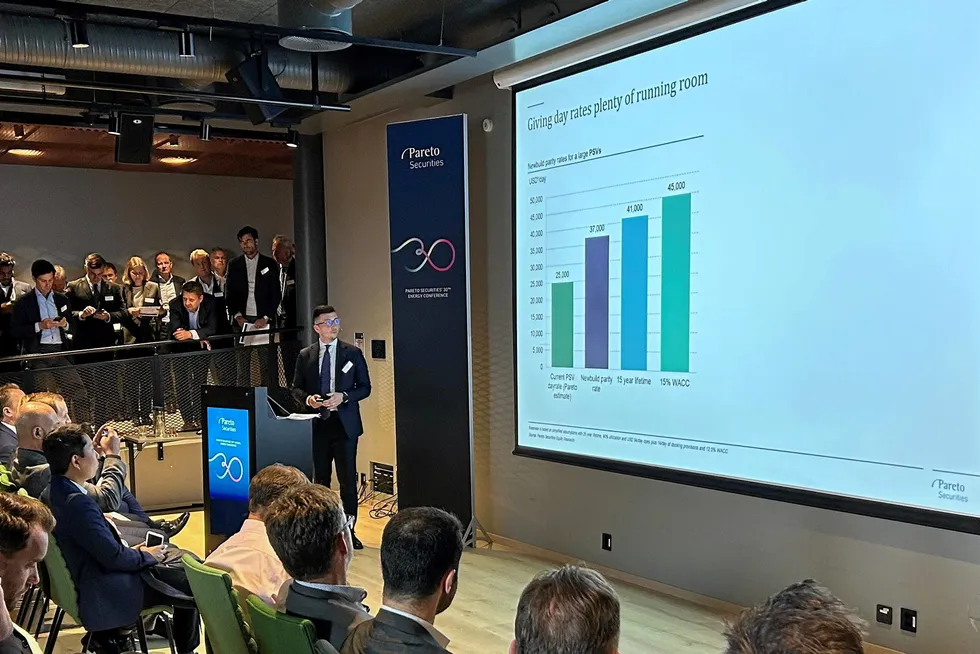 Pareto Securities analyst Joren Sovik Opheim, at podium, speaks at the company's Energy Conference in Oslo on 20 September, 2023. Opheim suggestd Subsea 7 could look to acquire Solstad Offshore.