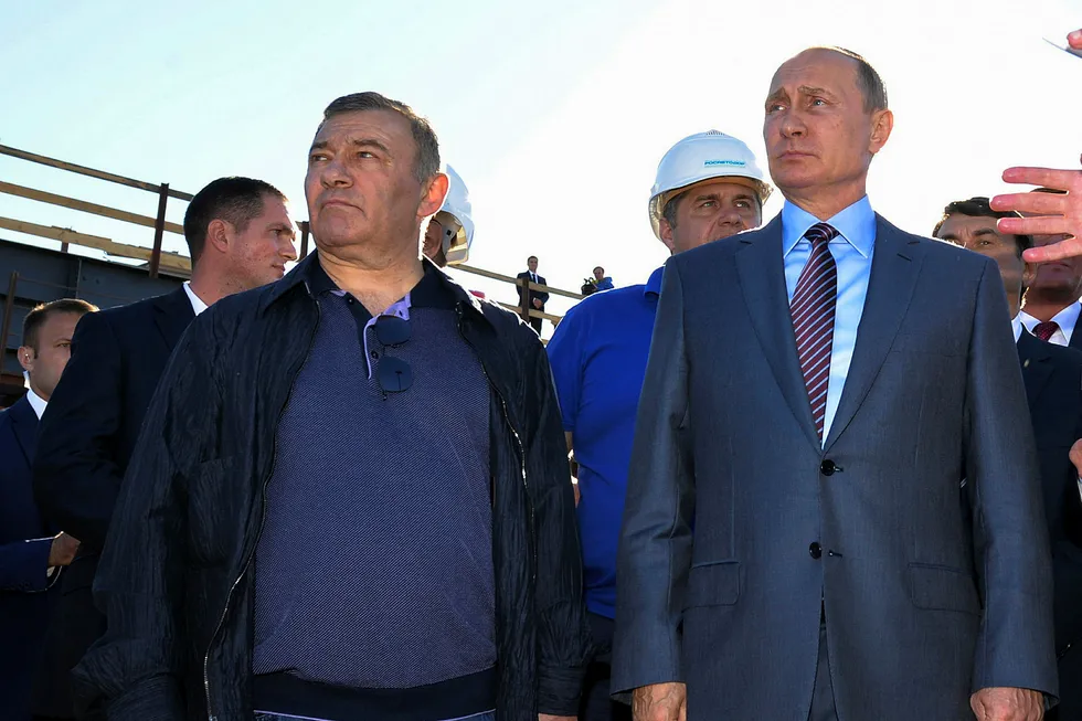 Lucrative awards: Russian President Vladimir Putin (right) stands next to businessman Arkady Rotenberg, who expanded into gas and LNG projects after earning billions of dollars in pipeline construction contracts from Gazprom