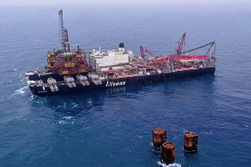 Removal: the Brent Bravo topsides being lifted by Allseas' Pioneering Spirit in June 2019, with teh concrete legs in view (bottom right)