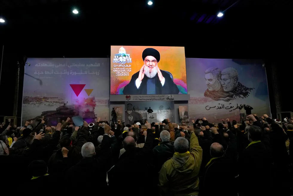 Reaction: Hezbollah leader Hassan Nasrallah greets his supporters via a video link in Beirut, Lebanon on 3 January.