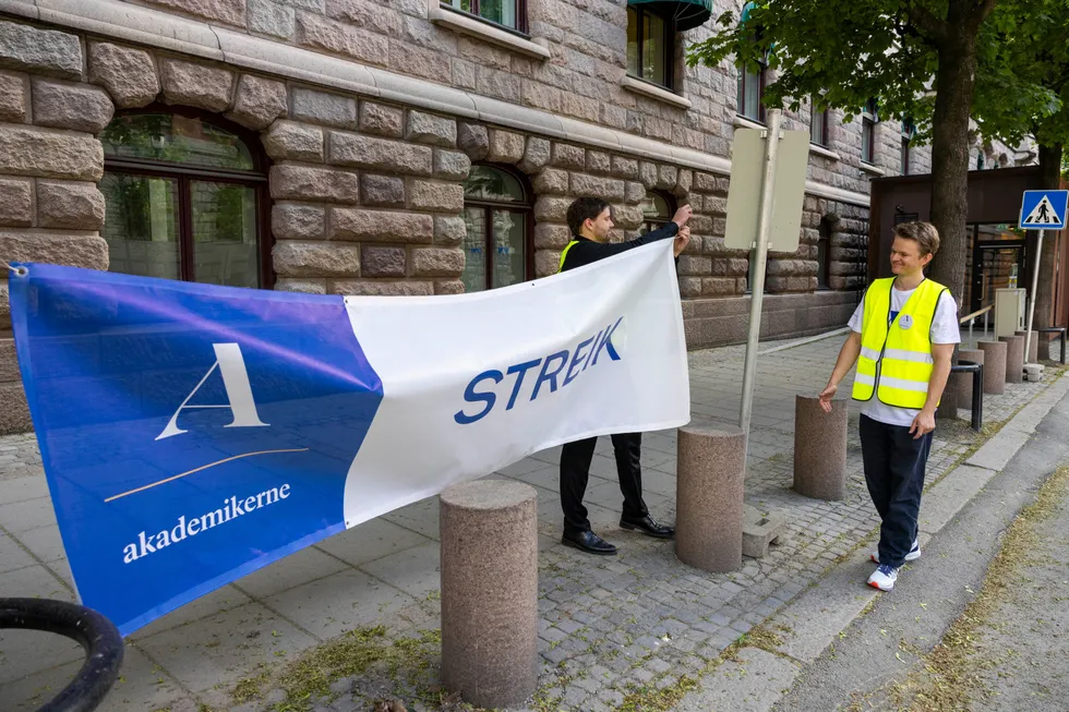 I slutten av mai streiket Akademikerne og Hjalmar Richter Kolsaker (til venstre) og Jens Furuholmen satte opp streikebanneret foran Finansdepartementet.