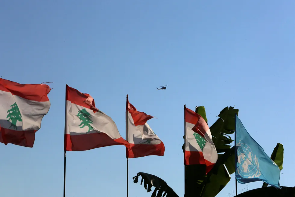 Dialogue: Lebanese and UN flags flutter as an aircraft flies in Naqoura ahead of talks between Israel and Lebanon on disputed waters