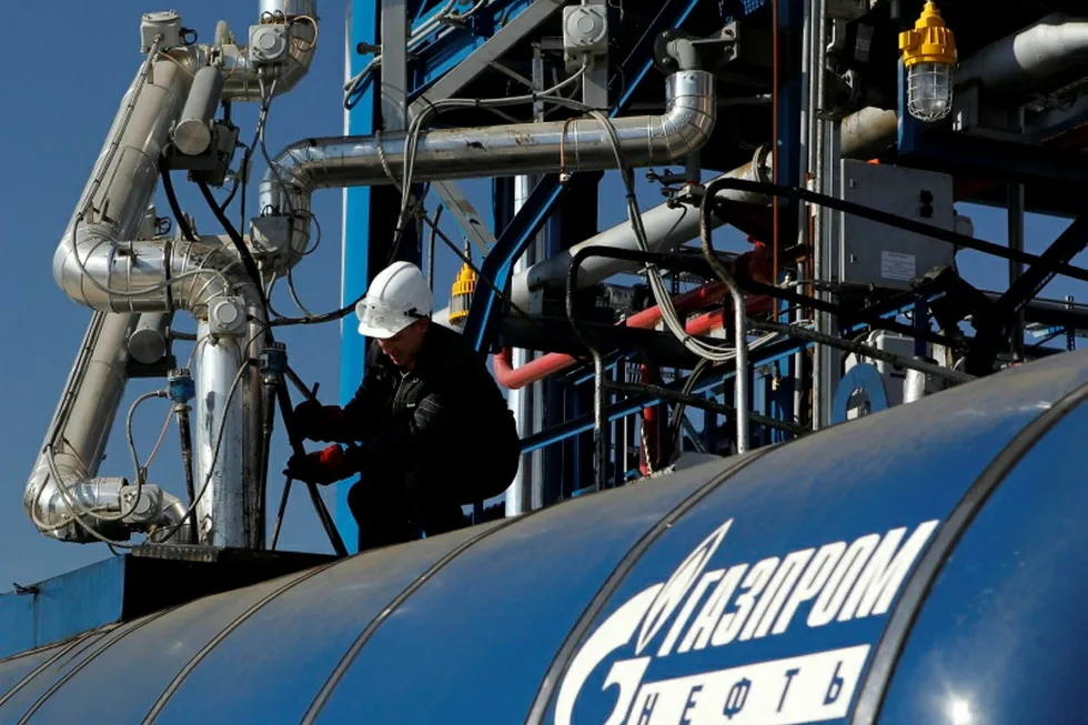 Gazprom Neft: An employee works on an equipment at the Gazprom Neft oil refinery
