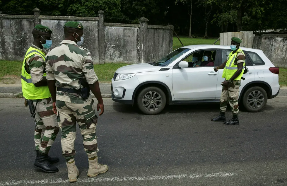 Lockdown: Gabonese presidential guards seen stopping a car at a checkpoint in Libreville in an attempt to combat the spread of Covid-19 coronavirus.