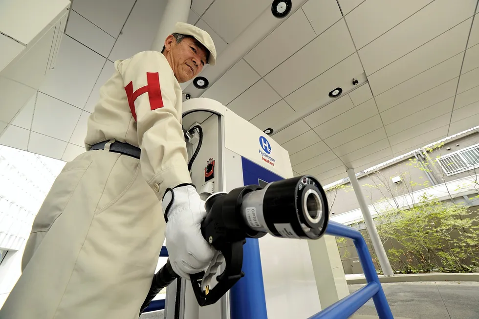 A worker at an Iwatani hydrogen filling station in Japan. A lack of refuelling infrastructure in many countries has been cited as one of the barriers to hydrogen fuel uptake in road transport.