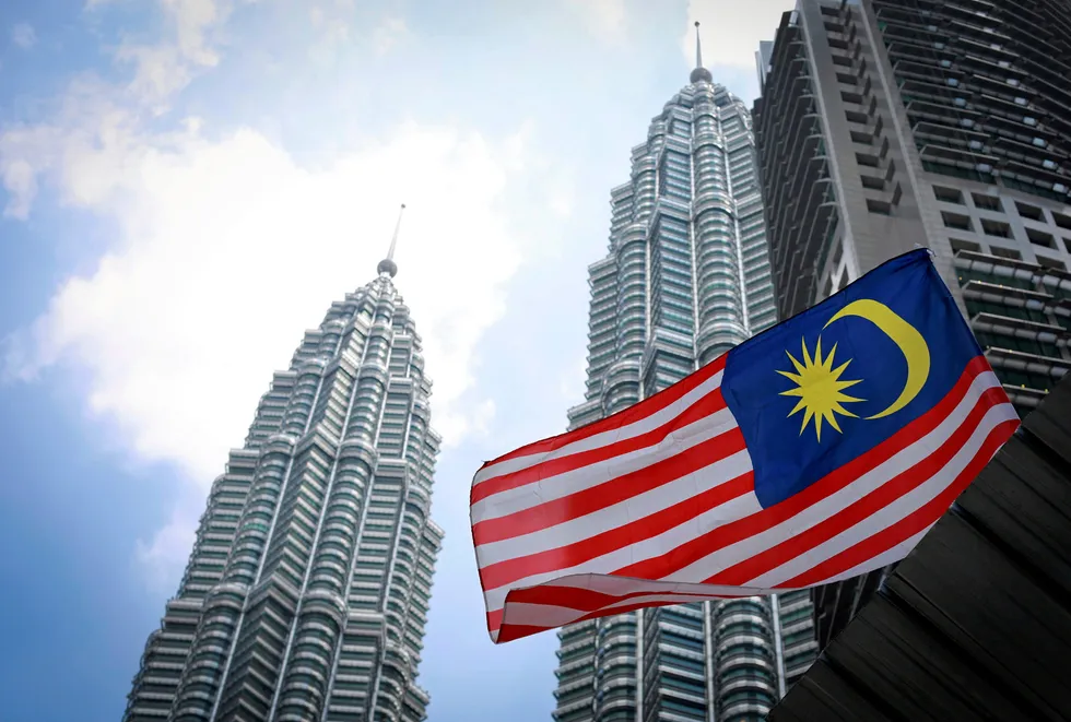 Headquarters: Malaysia’s national flag in front of the Petronas Twin Towers in Kuala Lumpur.