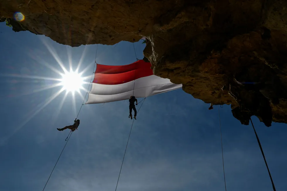 Patriotic: university students unfurl a large national flag during a ceremony for Indonesia's 77th Independence Day on 17 August 2022.