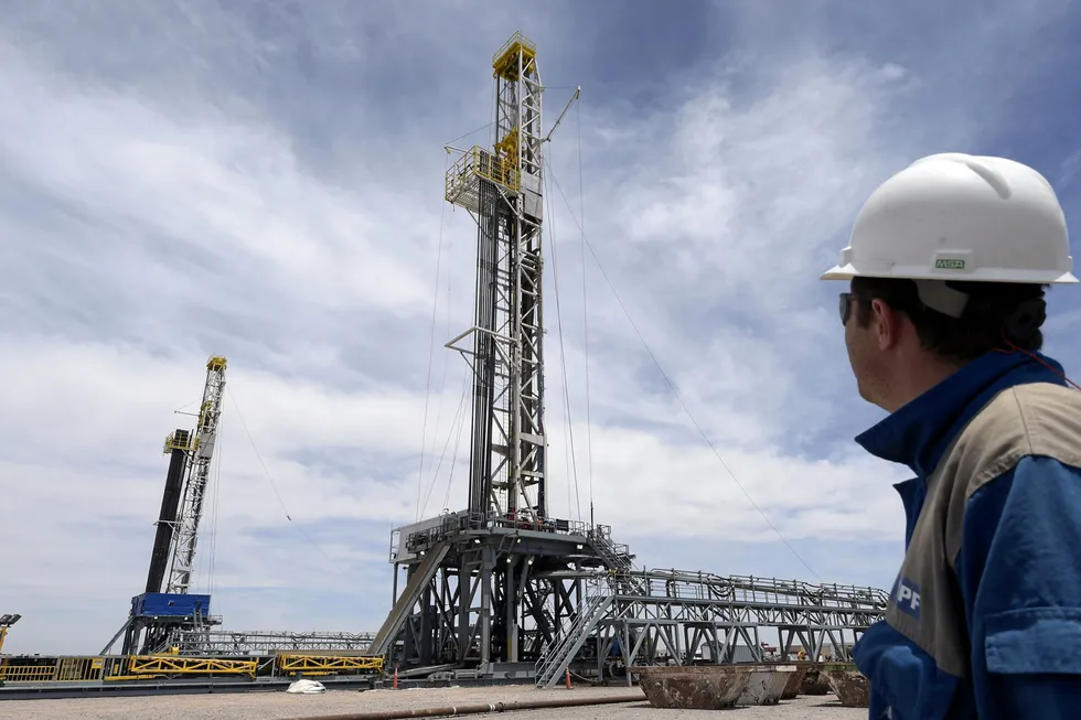 Loma Campana: a manager with Argentinian oil company YPF observes drilling rigs on one of the company's joint venture projects in the Vaca Muerta shale