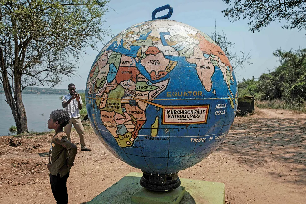 Prospects: a boy stands next to a globe statue at the Murchison Falls National Park in northwest Uganda