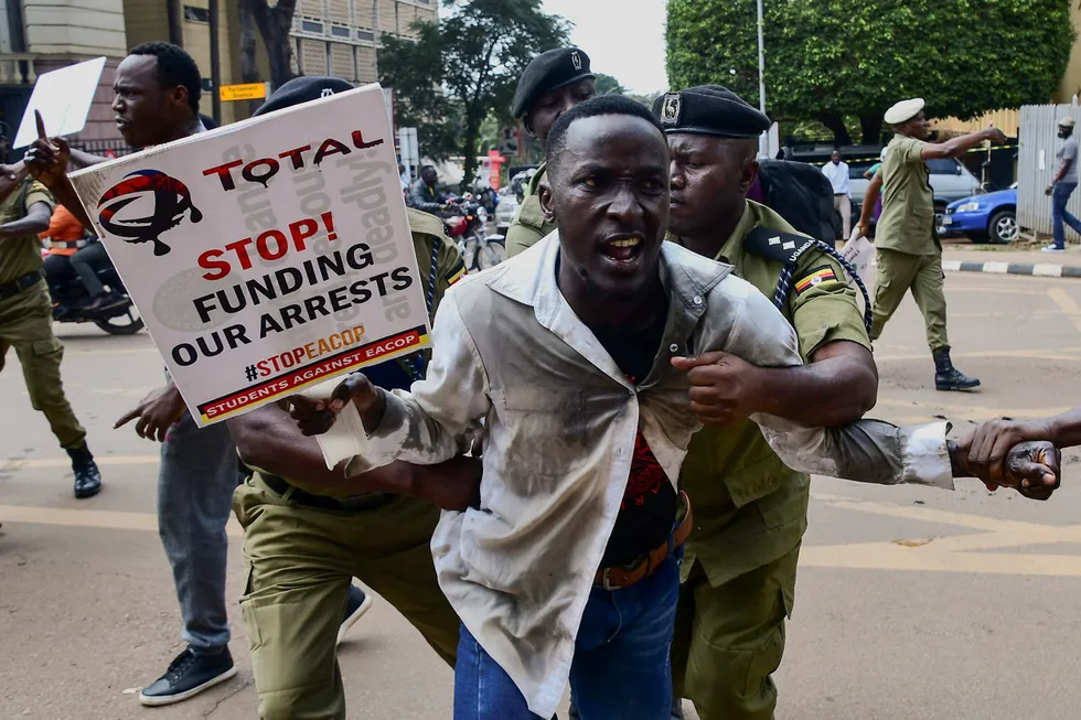 Crackdown: Police officers detain a Ugandan activist in Kampala who was participating in a demonstration over proposed plans by Total Energies and others to build the East African Crude Oil Pipeline (EACOP).