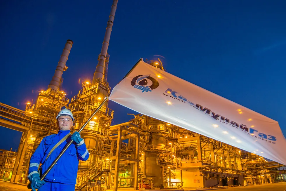 Flag carrier: A worker waiving KazMunaygaz flag at the Atyrau oil refinery in Kazakhstan.