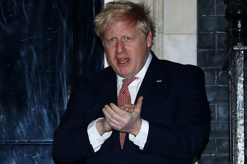 Appreciation: UK Prime Minister Boris Johnson outside 10 Downing Street on Thursday applauds National Health Workers in their fight against the coronavirus