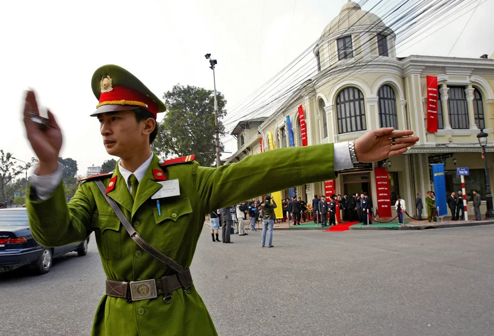 Direction: a policeman moves traffic in Hanoi, the capital of Vietnam