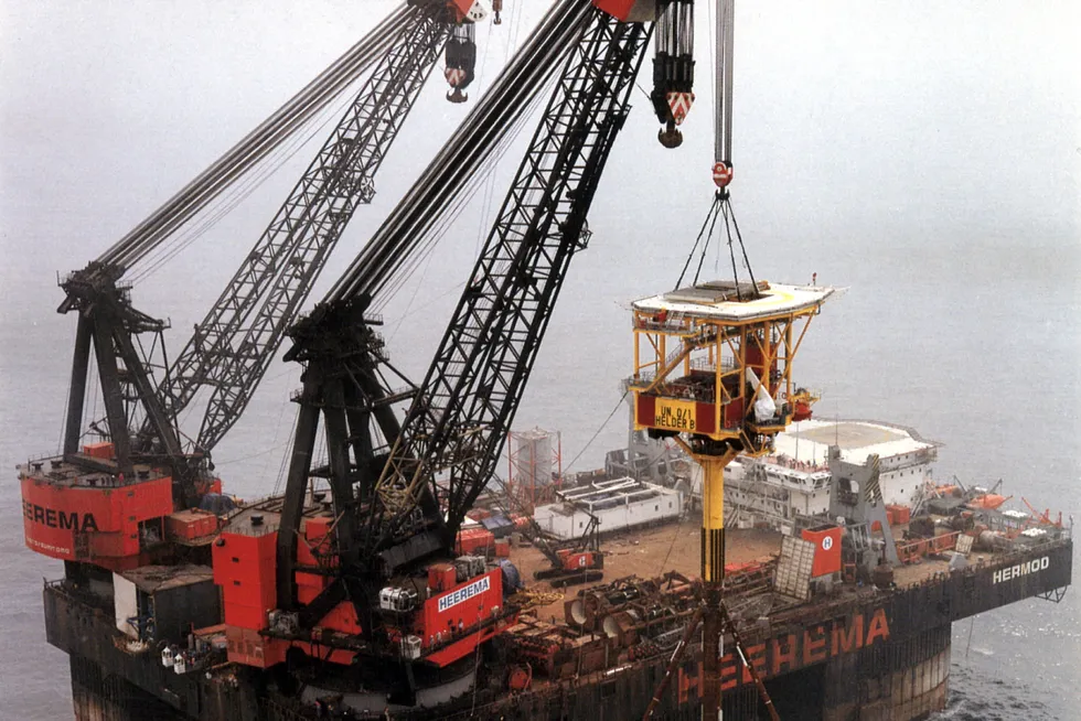 Installation: Heerema's Hermod floating crane lifting the tripod tower platform for the Helder field offshore The Netherlands in 1986