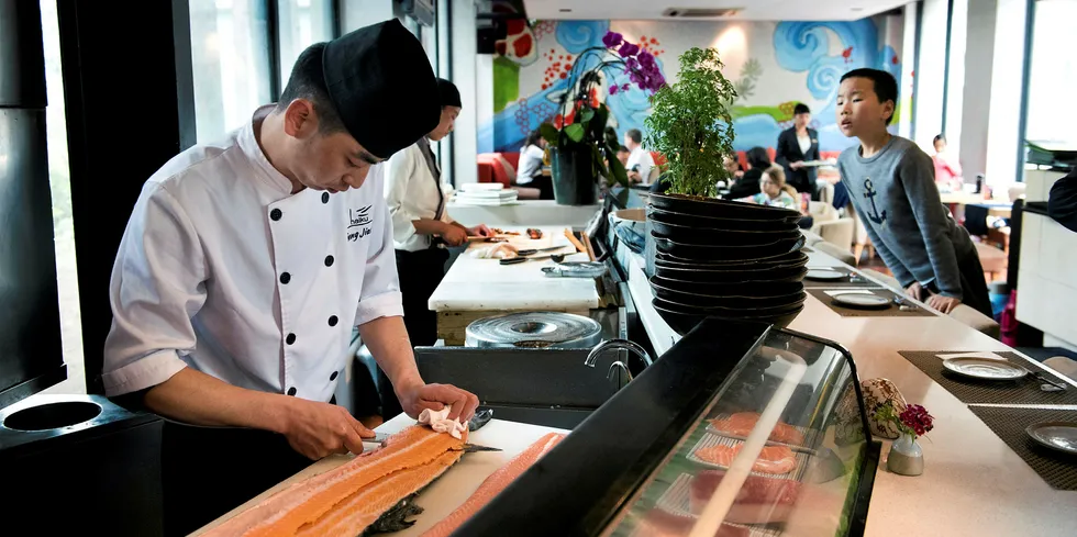 Haiku Chef Feng Jiang prepares Scottish salmon for serving. Chinese consumers are now scared of corona infection from all imported salmon.