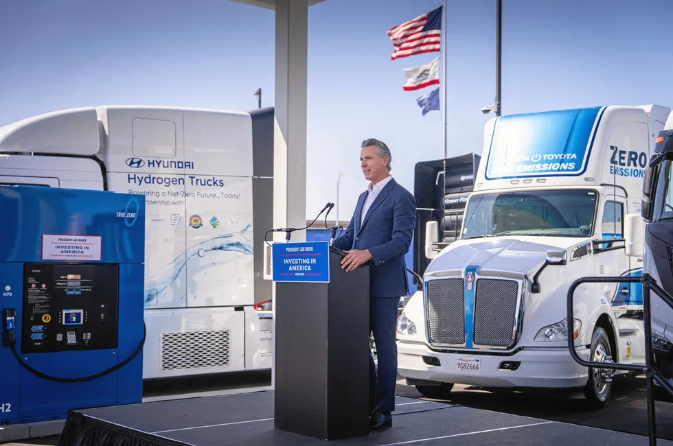 California governor Gavin Newsom speaking at the official launch of the ARCHES H2 project in July 2024, while posing with hydrogen trucks at a hydrogen refuelling station.