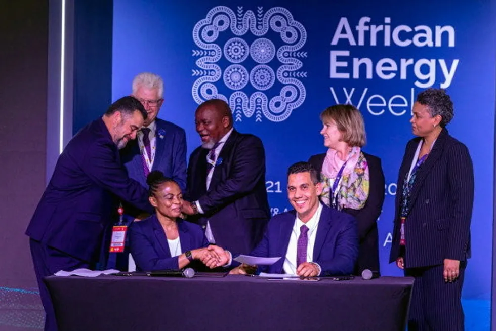 Happy faces: Priscillah Mabelane, head of Sasol’s energy business (front left) and Kobus Verster, chief executive of ArcelorMittal South Africa (front right) sign deals, with South African Energy Minister Gwede Mantashe showing his excitement (back - centre)