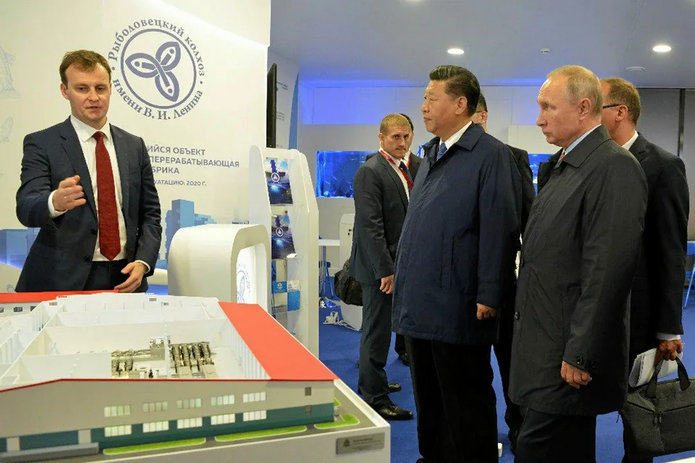 Russian Fishery CEO Fedor Kirsanov (left) shows off the group's investments plans to Vladimir Putin and Xi Jinping.