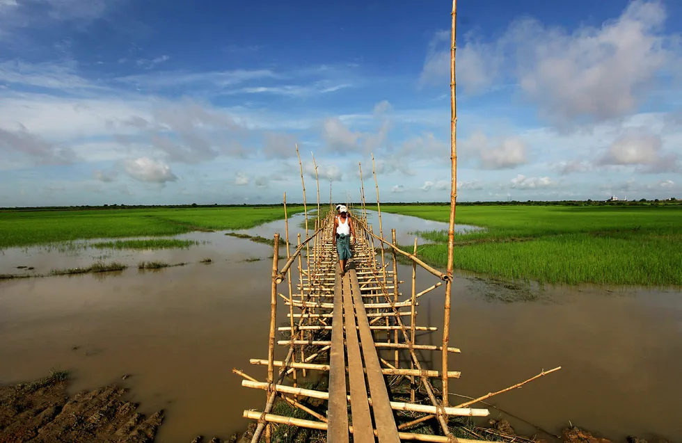 New facility: people walk on a wooden bridge at the Thilawa Special Economic Zone outside Yangon