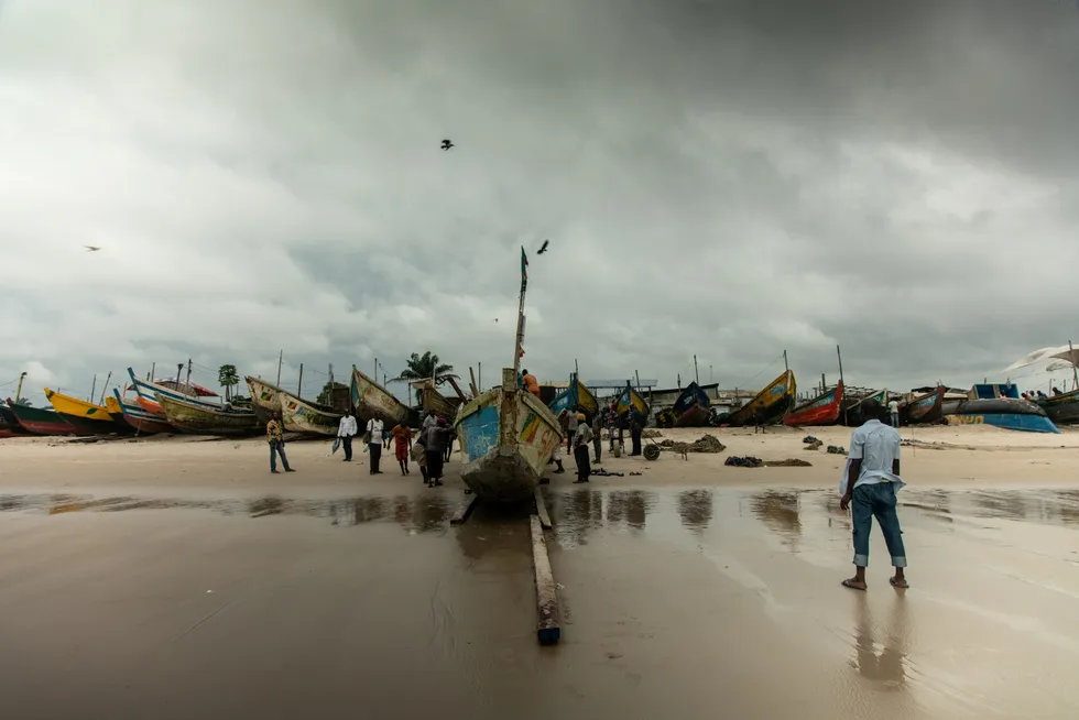 Eyes on big catch: fishermen push a pirogue out to sea from Songolo beach in Pointe-Noire, Congo-Brazzaville