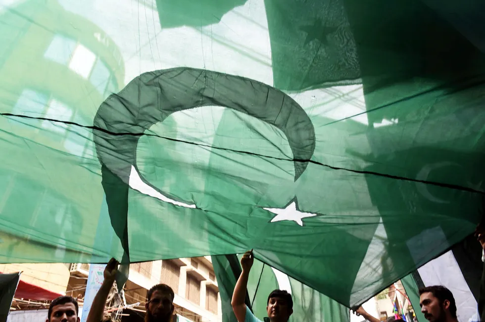 Exploration: People carrying the flag of Pakistan.