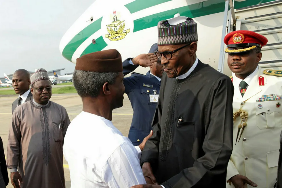 Back: Nigerian Vice President Professor Yemi Osinbajo (left) welcomes President Mohammadu Buhari (right) on his return to Abuja