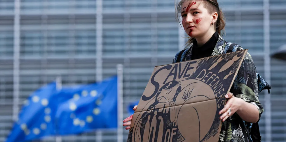 A woman takes part in a rally to call on EU countries to stop buying Russian gas.