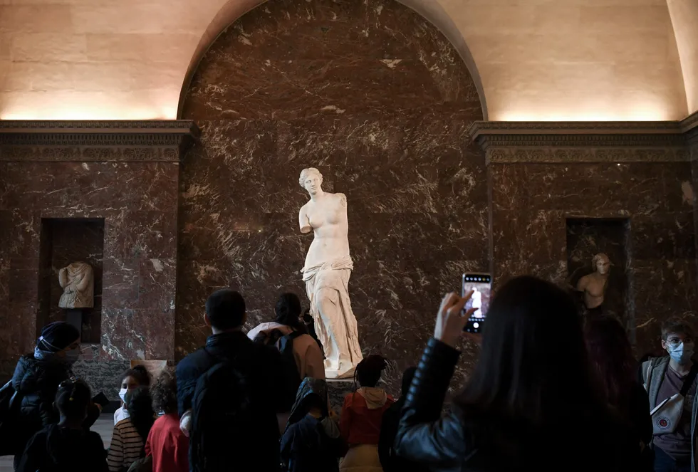 All eyes on Venus: visitors gather in front of the ancient Greek sculpture Venus de Milo at the Louvre Museum, Paris