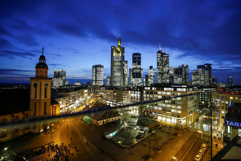 Hovedkontoret til Commerzbank i midten til venstre og Deutsche Banks tvillingtårn til høyre lyser opp i finansdistriktet rundt Hauptwache square i Frankfurt i Tyskland.