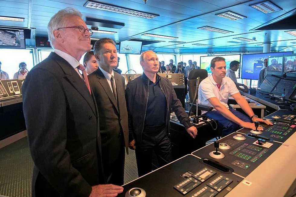 All aboard: Allseas founder Edward Heerema (left) with Gazprom CEO Alexei Miller and President Vladimir Putin on board the Pioneering Spirit