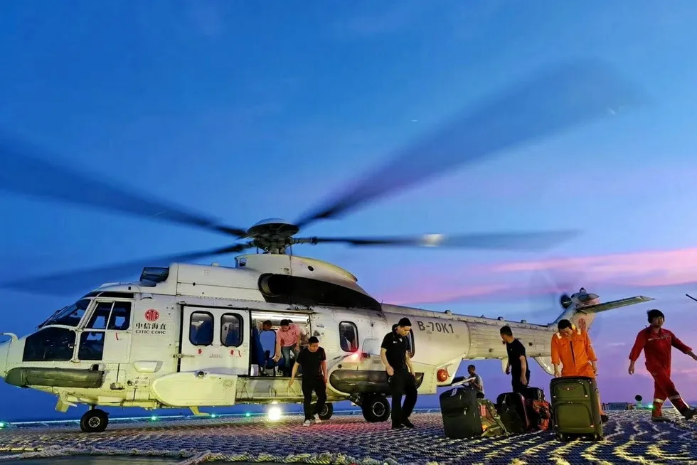 Evacuation: Helicopter ferries CNOOC crew ashore ahead of Super Typhoon Saola last weekend.