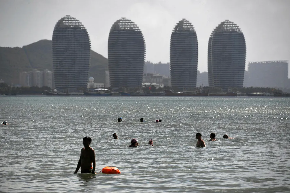 Testing the waters: people swim at a beach in Sanya in China's island province of Hainan