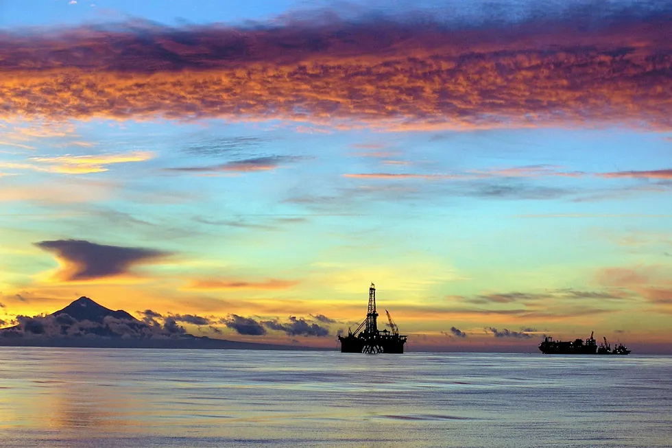 Action plan: sunset over the Tui field off New Zealand with the drilling rig Ocean Patriot and the Umuroa FPSO on the right