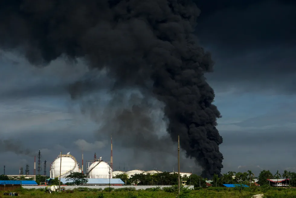 Blaze: a Cilacap oil depot belonging to state oil company Pertamina emits thick black smoke after the refinery fire the previous day in June