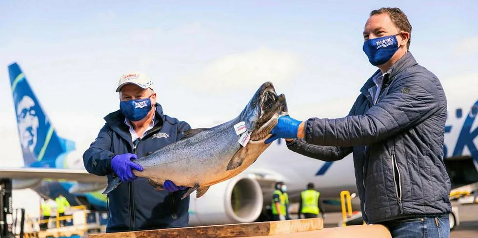 Vic Scheibert, left, who manages operations for Trident Seafoods in Alaska and Trident CEO Joe Bundrant hold up the first Copper River salmon to arrive in Seattle this year. Scheibert is one of three long-time Trident execs departing the company as part of a reorganization.