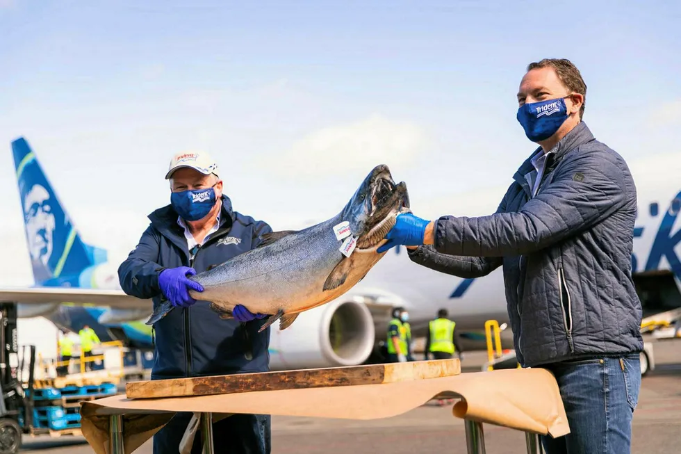 Vic Scheibert, left, who manages operations for Trident Seafoods in Alaska and Trident CEO Joe Bundrant hold up the first Copper River salmon to arrive in Seattle this year. Scheibert is one of three long-time Trident execs departing the company as part of a reorganization.