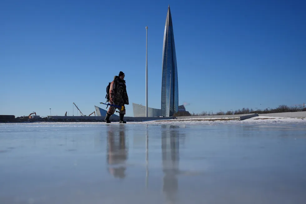 Accelerating pace: A fisherman walks on Finnish Gulf ice near the Lakhta Centre, the headquarters of Gazprom in St Petersburg, Russia.
