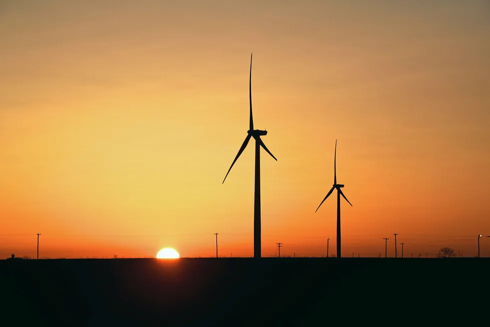 Old and new: Wind turbines operate at sunrise in the Permian Basin in Big Spring, Texas