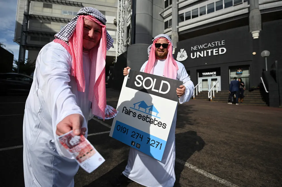 Fantasy: Newcastle United supporters dressed in robes as they celebrate the sale of the club to a Saudi-led consortium